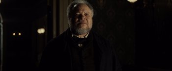 Movie still from “Lincoln” (2012), directed by Steven Spielberg – An old man with a beard wearing a suit and tie; Close Up shot, Low angle