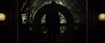 Movie still from “Lincoln” (2012), directed by Steven Spielberg – A man standing in front of an archway in the dark; Wide shot, Low angle