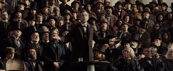 Movie still from “Lincoln” (2012), directed by Steven Spielberg – A crowd of people standing in front of a man in a suit; Wide shot, Low angle
