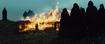 Movie still from “Macbeth” (2015), directed by Justin Kurzel – A couple of people standing in front of a fire; Wide shot, Low angle