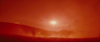 Movie still from “Macbeth” (2015), directed by Justin Kurzel – Two people standing in a field with a sunset in the background; Extreme Wide shot, Low angle