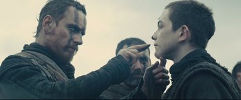 Movie still from “Macbeth” (2015), directed by Justin Kurzel – A man pointing to another man's face with a finger; Close Up shot, Over the shoulder angle