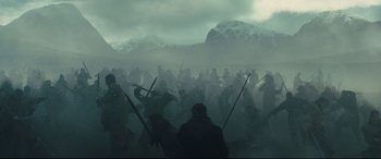 Movie still from “Macbeth” (2015), directed by Justin Kurzel – A group of people standing in the middle of a field; Extreme Wide shot, High angle