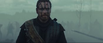 Movie still from “Macbeth” (2015), directed by Justin Kurzel – A person wearing a costume; Medium shot, Over the shoulder angle