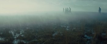 Movie still from “Macbeth” (2015), directed by Justin Kurzel – A group of people standing on top of a grass covered field; Extreme Wide shot, Low angle