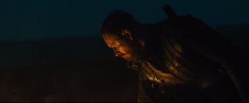 Movie still from “Macbeth” (2015), directed by Justin Kurzel – A man with a beard is looking down at the ground; Close Up shot, Low angle