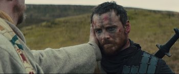 Movie still from “Macbeth” (2015), directed by Justin Kurzel – A person holding his hand up to his face; Close Up shot, Over the shoulder angle