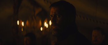 Movie still from “Macbeth” (2015), directed by Justin Kurzel – A man with a goatee stares into the light; Close Up shot, Low angle