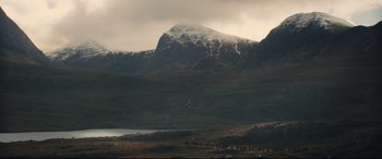 Movie still from “Macbeth” (2015), directed by Justin Kurzel – A view of a mountain range with snow on it; Extreme Wide shot, High angle