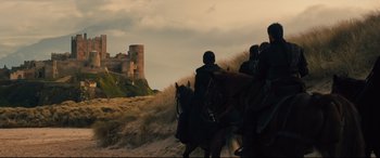 Movie still from “Macbeth” (2015), directed by Justin Kurzel – A group of people riding horses on a beach; Extreme Wide shot, Low angle
