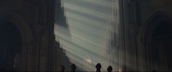 Movie still from “Macbeth” (2015), directed by Justin Kurzel – A group of people standing on top of a building; Extreme Wide shot, Low angle
