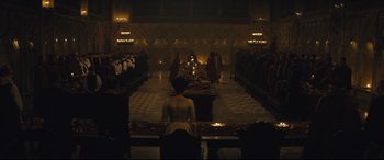 Movie still from “Macbeth” (2015), directed by Justin Kurzel – A group of people standing around a room; Extreme Wide shot, High angle
