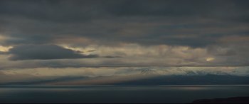 Movie still from “Macbeth” (2015), directed by Justin Kurzel – A view of a large body of water with a mountain in the background; Extreme Wide shot, Low angle