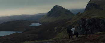 Movie still from “Macbeth” (2015), directed by Justin Kurzel – A man riding a horse on top of a hill; Extreme Wide shot, Over the shoulder angle