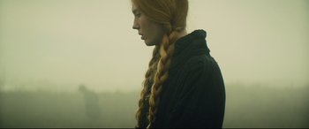 Movie still from “Macbeth” (2015), directed by Justin Kurzel – A woman with long red hair and a black shirt; Close Up shot, Over the shoulder angle
