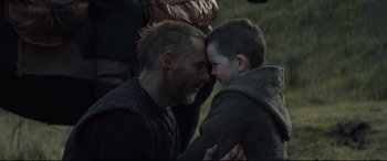 Movie still from “Macbeth” (2015), directed by Justin Kurzel – A man and a boy are looking into each others eyes; Close Up shot, Over the shoulder angle