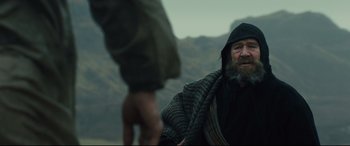 Movie still from “Macbeth” (2015), directed by Justin Kurzel – A man with a beard is holding a towel over his head; Medium shot, Over the shoulder angle