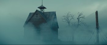 Movie still from “Macbeth” (2015), directed by Justin Kurzel – A church with a steeple in the middle of a foggy field; Extreme Wide shot, Low angle
