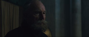 Movie still from “Macbeth” (2015), directed by Justin Kurzel – An old man with a beard is looking at the camera; Close Up shot, Low angle