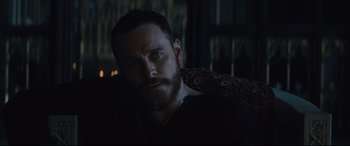 Movie still from “Macbeth” (2015), directed by Justin Kurzel – A man with a beard sitting in a dark room; Close Up shot, Over the shoulder angle