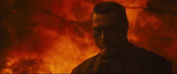 Movie still from “Macbeth” (2015), directed by Justin Kurzel – A person wearing a mask in front of a fire background; Close Up shot, Low angle