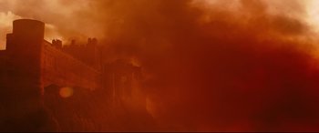 Movie still from “Macbeth” (2015), directed by Justin Kurzel – A red sky with a building in the background; Extreme Wide shot, Low angle