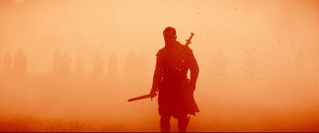 Movie still from “Macbeth” (2015), directed by Justin Kurzel – A man with a sword in the middle of a dust storm; Wide shot, Low angle