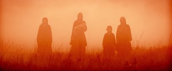 Movie still from “Macbeth” (2015), directed by Justin Kurzel – A group of people standing in a foggy field; Wide shot, Low angle