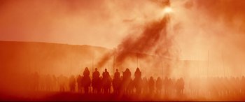 Movie still from “Macbeth” (2015), directed by Justin Kurzel – A large group of people riding horses in a field; Extreme Wide shot, Low angle