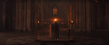 Movie still from “Macbeth” (2015), directed by Justin Kurzel – A man sitting in a chair in a cathedral; Extreme Wide shot, High angle