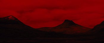 Movie still from “Macbeth” (2015), directed by Justin Kurzel – A red sky with a mountain in the background; Extreme Wide shot, High angle