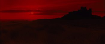 Movie still from “Macbeth” (2015), directed by Justin Kurzel – The sun is setting in the sky over a large field; Extreme Wide shot, Low angle