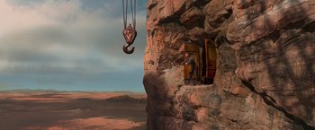 Movie still from “Mad Max: Fury Road” (2015), directed by George Miller – A man standing in front of an open door; Extreme Wide shot, Overhead angle