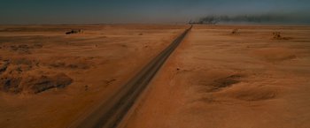 Movie still from “Mad Max: Fury Road” (2015), directed by George Miller – An empty road in the middle of a barren desert; Extreme Wide shot, High angle