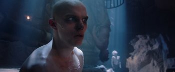 Movie still from “Mad Max: Fury Road” (2015), directed by George Miller – A man with a bald head is looking at the camera; Close Up shot, Low angle