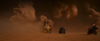 Movie still from “Mad Max: Fury Road” (2015), directed by George Miller – A man driving a vehicle in the desert; Extreme Wide shot, Low angle