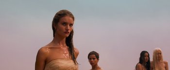Movie still from “Mad Max: Fury Road” (2015), directed by George Miller – A woman standing next to another woman in the water; Close Up shot, Low angle