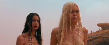 Movie still from “Mad Max: Fury Road” (2015), directed by George Miller – Two young women standing next to each other; Close Up shot, Low angle