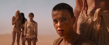 Movie still from “Mad Max: Fury Road” (2015), directed by George Miller – A man and a woman standing in the desert; Close Up shot, Low angle