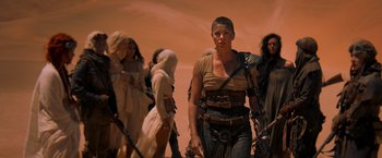 Movie still from “Mad Max: Fury Road” (2015), directed by George Miller – A group of people standing in the desert; Wide shot, Low angle