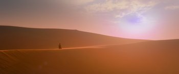 Movie still from “Mad Max: Fury Road” (2015), directed by George Miller – A person standing in the middle of the desert; Extreme Wide shot, Low angle