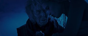 Movie still from “Mad Max: Fury Road” (2015), directed by George Miller – An old man and a young woman kissing in the dark; Close Up shot, Over the shoulder angle