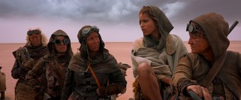 Movie still from “Mad Max: Fury Road” (2015), directed by George Miller – Two people in the desert looking at each other; Medium shot, Over the shoulder angle