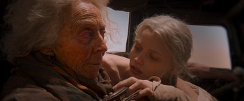 Movie still from “Mad Max: Fury Road” (2015), directed by George Miller – An older woman and a younger woman looking at each other; Close Up shot, Over the shoulder angle