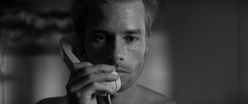 Movie still from “Memento” (2000), directed by Christopher Nolan – A person holding a cell phone; Close Up shot, Low angle