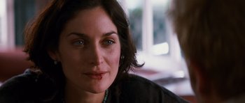 Movie still from “Memento” (2000), directed by Christopher Nolan – A woman's face with blood on her cheek; Close Up shot, Over the shoulder angle