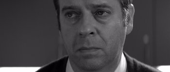 Movie still from “Memento” (2000), directed by Christopher Nolan – Black and white photograph of a man's face; Close Up shot, Low angle