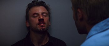 Movie still from “Memento” (2000), directed by Christopher Nolan – A man with blood all over his face; Close Up shot, Low angle