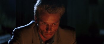 Movie still from “Memento” (2000), directed by Christopher Nolan – A person wearing a suit; Close Up shot, Low angle