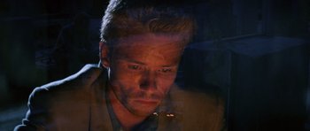 Movie still from “Memento” (2000), directed by Christopher Nolan – A person looking at the camera; Close Up shot, High angle